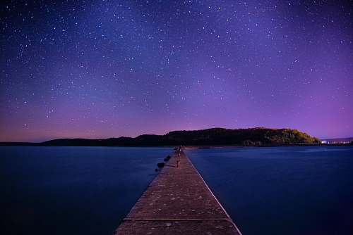 galaxy brown wooden dock under night sky pier